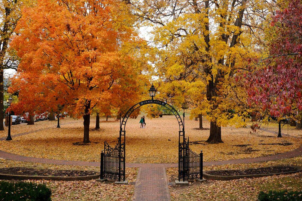 People walk through Gratz Park in Lexington surrounded by brightly colored leaves. Tuesday’s weather calls for partly sunny skies and a high temperature in the mid-60s, according to the National Weather Service. 