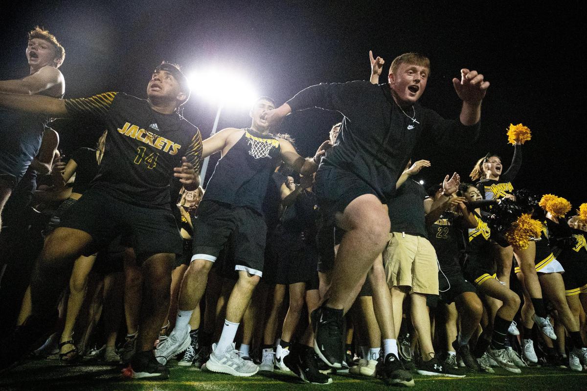 Woodford County students rushed the field after their school’s 24-21 defeat of Franklin County on Friday in Versailles.