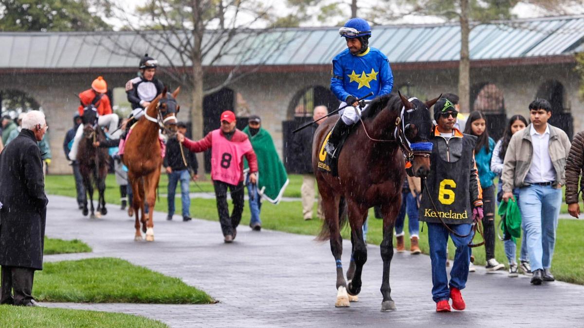 Horses exit Keeneland’s paddock before the first race of the 2022 Spring Meet.
