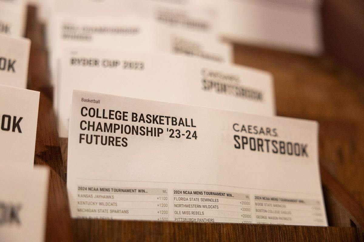 College basketball betting sheets from Caesars Sportsbook are on display at Red Mile in Lexington. In-person sports gambling began in Kentucky this month, with mobile wagering available in the state Thursday.
