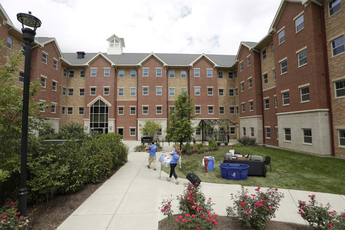Volunteers Adam Clem and Cassady Gorrell helped move other students into Lyman T. Johnson Hall on Wednesday. The dorm is next to the library.
