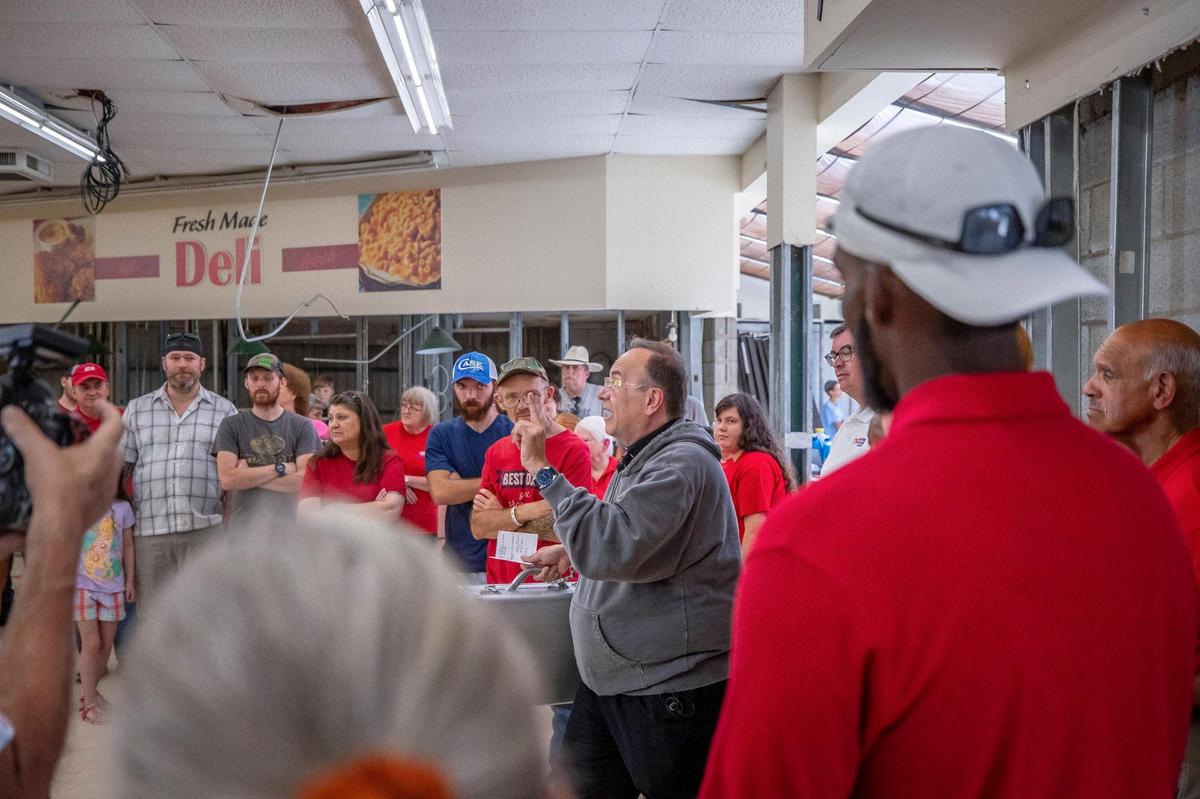 Father Jim Sichko — the Papal Missionary of Mercy from Lexington — explains why he’s giving a case containing $75,000 to Gwen and Arthur Christon to help reopen the Isom IGA grocery store they own on Wednesday, Aug. 31, 2022. The grocery store was devastated by flood waters in July.