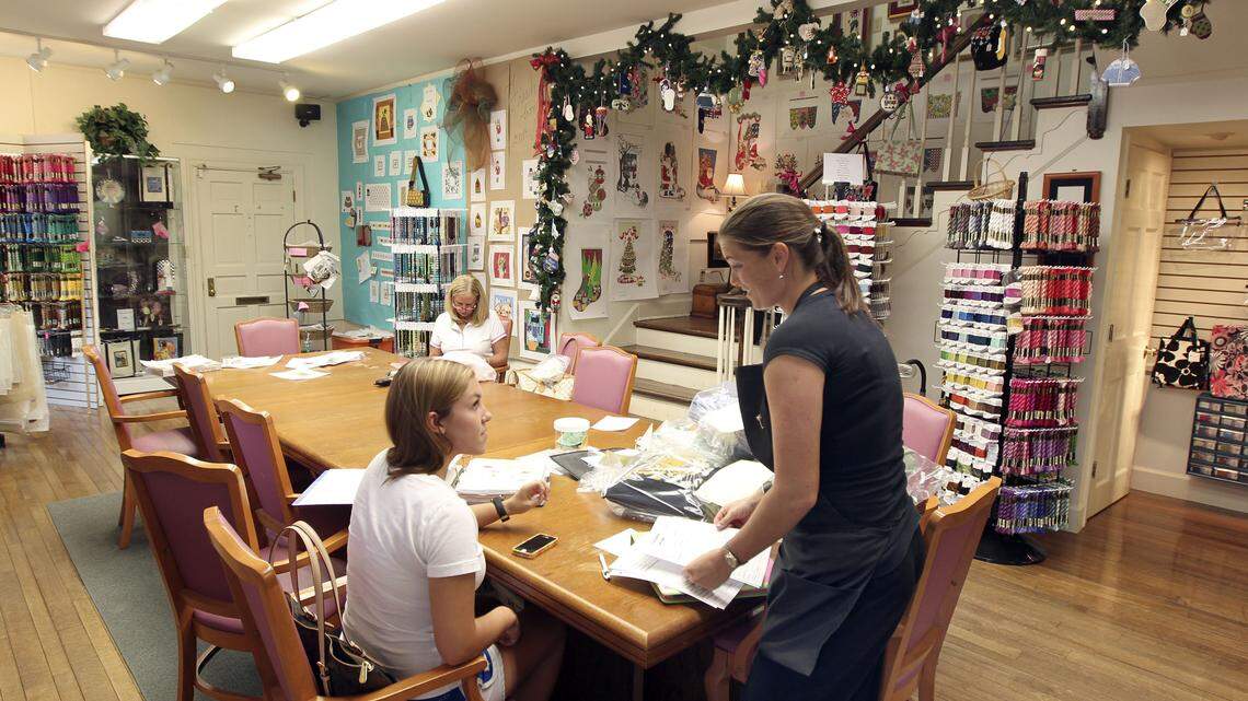 Employee Caroline Greathouse, right, helped customer Nicole Davenport with a belt she was making, and customer Susan Donovan, background, worked on her belt. "Belts are always big," owner Meredith Willett said.