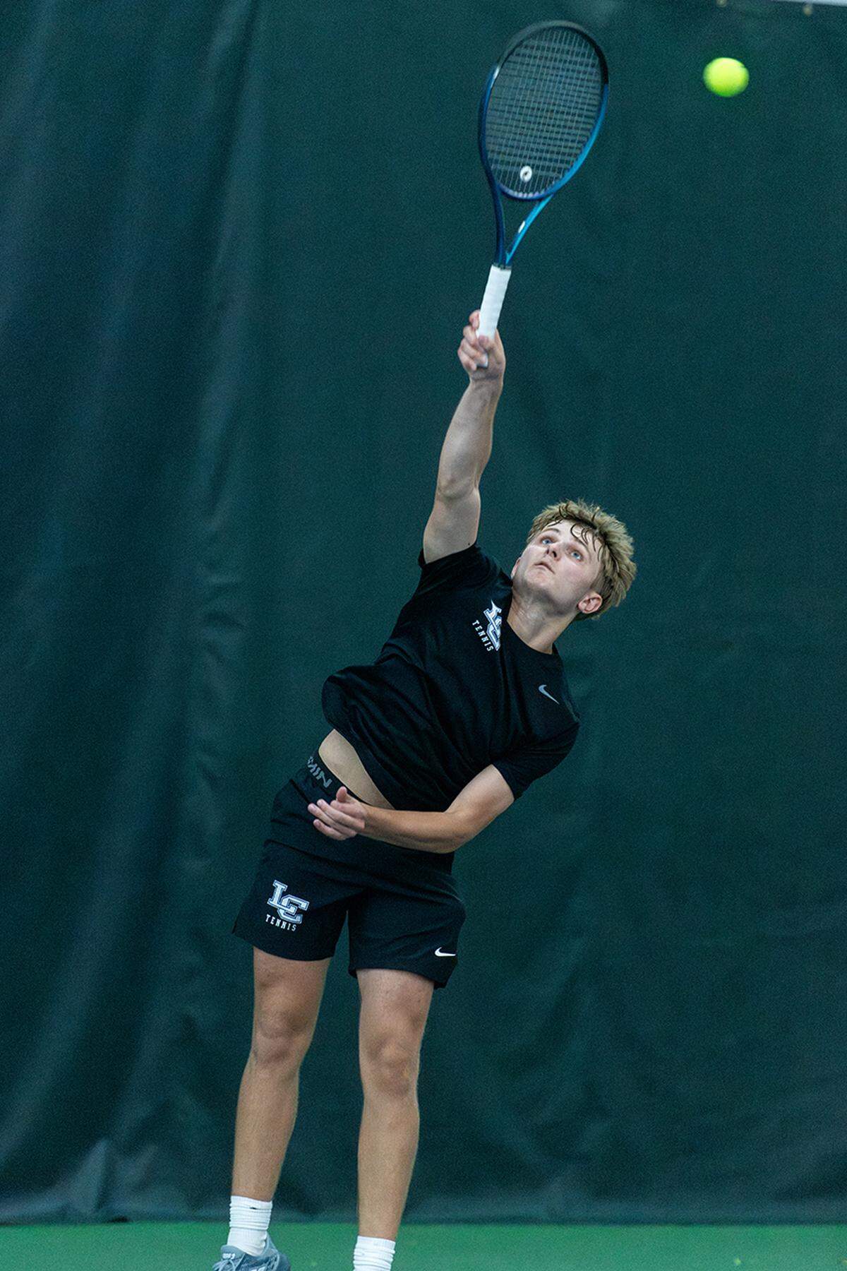 Lexington Catholic’s Jacob Holland serves Friday during his doubles win with Clark Malone in the 11th Region championships at the Bluegrass Racquet Club in Nicholasville.