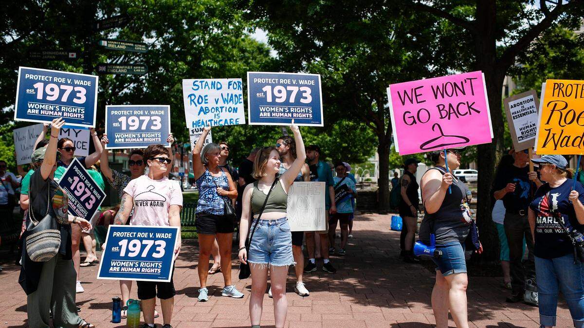 Protesters cheer and gather outside the courthouse during the Rise Up 4 Abortion Rights protest in downtown Lexington, Ky., Saturday, May 14, 2022.