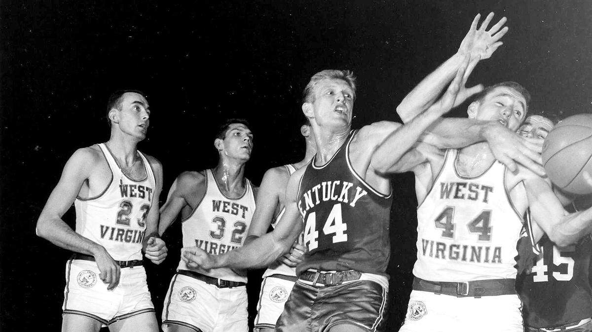 Kentucky’s Cotton Nash battles for a loose ball during the ninth-ranked Cats’ UKIT championship game against No. 7 West Virginia in Memorial Coliseum in 1962. Despite trailing by five at halftime, UK went on to win 79-75 behind Nash’s 30 points.