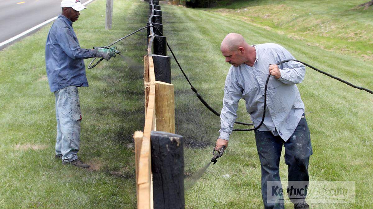 Tony King, left, and Dave Tice of Kentucky Farm Painting Co. painted new white oak fencing Monday at Bel-Mar Farm on Old Richmond Road in Lexington.