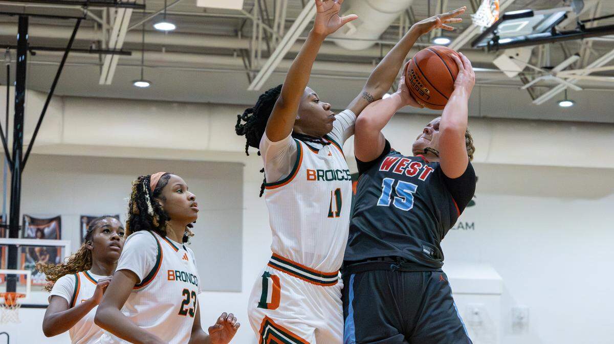 Jessamine's Claire Marshall (15) turns to shoot over Frederick Douglass guard MK Bennett (11) during their girls basketball game at The Farm on Wednesday, Jan. 14, 2026, in Lexington, Ky.