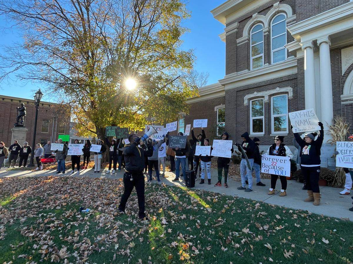 Loved ones of Desman LaDuke stand outside of the Jessamine County Courthouse with signs demanding justice for LaDuke.