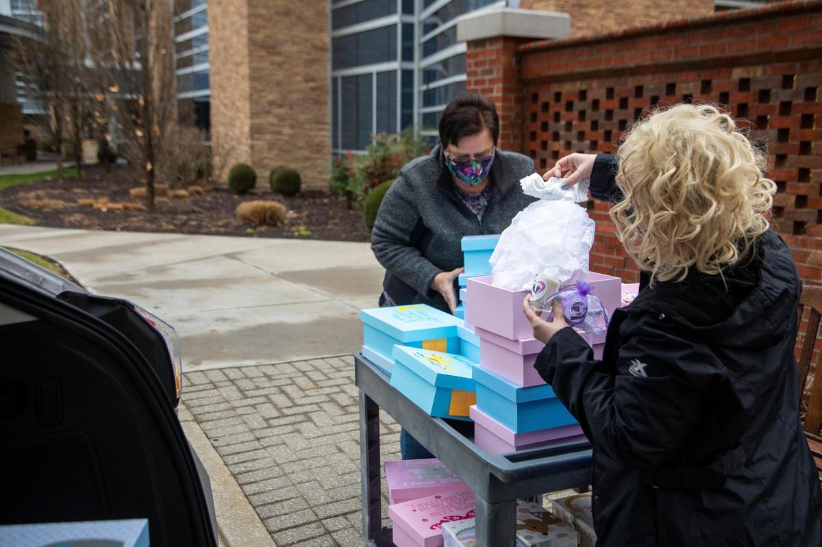 Tammy Marcum and Sandra Turner deliver a load of boxes to nurse Debbie Mueller, the paternal bereavement coordinator at Baptist Health in Lexington, Ky., Monday, December 14, 2020. Marcum has been delving boxes to Baptist Health for many years. “Knowing the heartbreak of that, I would have loved to have one of the boxes that I make, because that would have meant everything to me,” Marcum said.