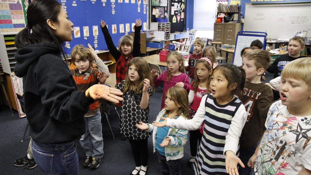 Japanese instructor Miko Momozono concluded one of her lessons at Picadome Elementary by singing, in Japanese, a "lost kitten story" song. Among those singing along were Nicolas Russell, 7, right, and Rachel Ha (wearing stripes), 6. Momozono teaches in each kindergarten through third-grade class for 20 minutes a day.    