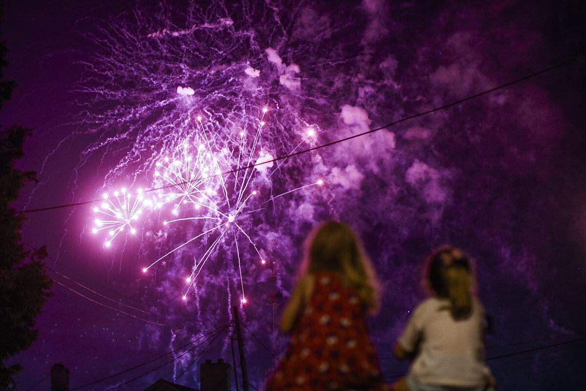 Spectators watch the city of Lexington’s Fourth of July fireworks display along Main Street in Lexington Ky., Thursday, July 4, 2019. Fireworks were launched from the R.J. Corman Railyard.