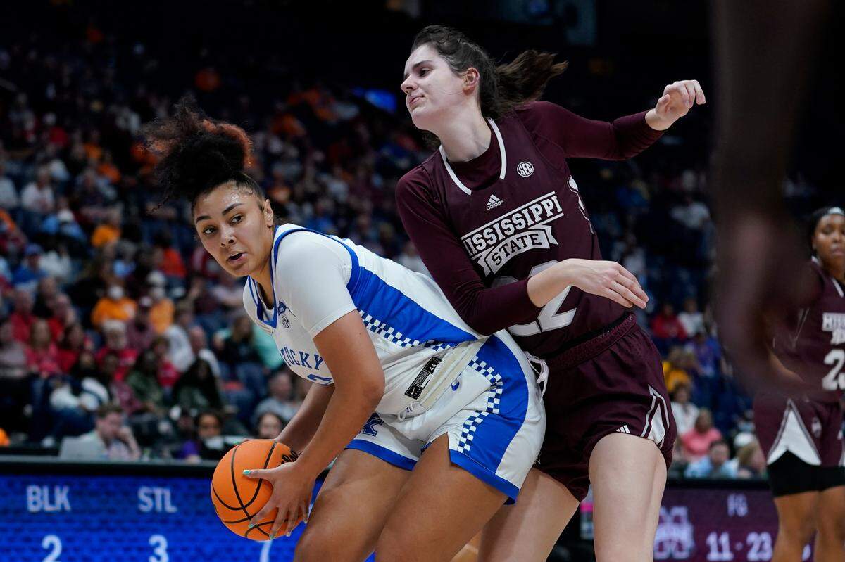 Kentucky’s Treasure Hunt, left, protects the ball from Mississippi State’s Charlotte Kohl during the first half Thursday night in Nashville.