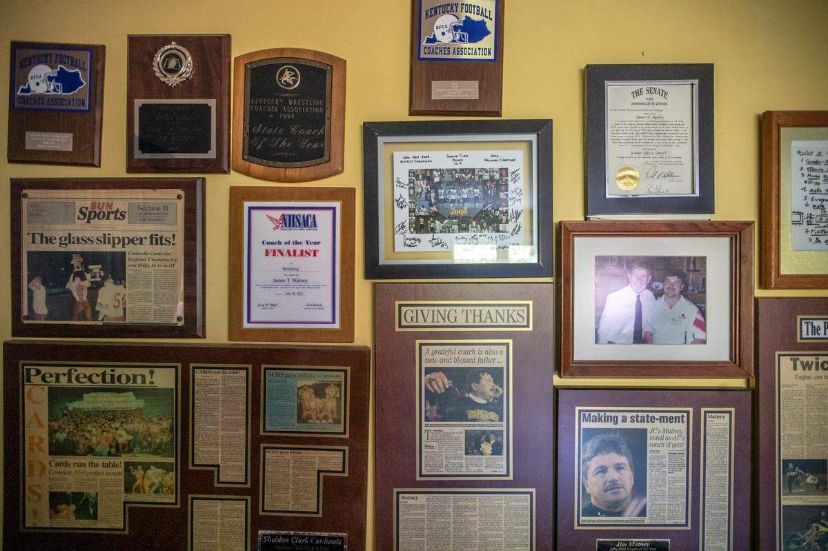 Newspaper clippings and awards covered a wall in the living room of the house Johnson Central head coach Jim Matney lived with his wife and children in Johnson County.