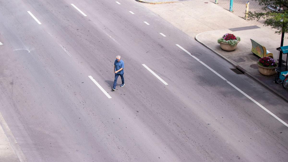 Man walks across West Main Street on Monday, Aug. 12, 2024, in Lexington, Kentucky.