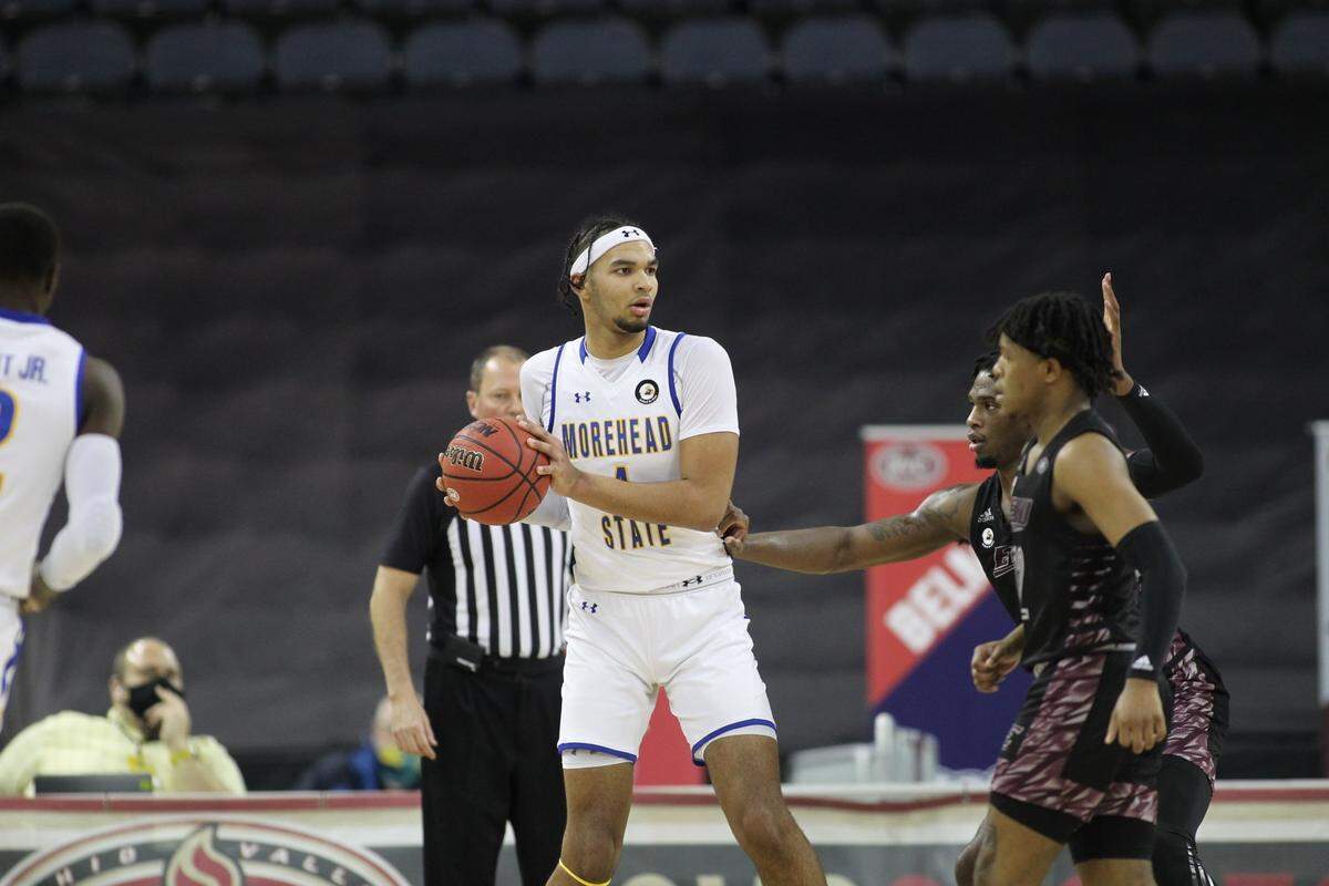 Former Morehead State star Johni Broome, center, scored 17 points to lead the Eagles to a 67-64 win over Eastern Kentucky in the semifinals of the 2021 Ohio Valley Conference Tournament in Evansville, Ind. With EKU leaving the OVC to join the ASUN Conference in 2021-22, the two ancient rivals have not played since. Morehead State athletics director Kelly Wells said last week the Eagles and Colonels will not renew their men’s hoops rivalry in 2024-25, either.