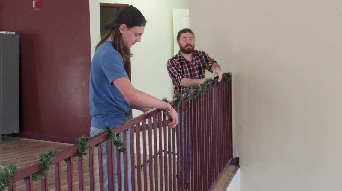 Jarred Stumbo, left, and teacher Austin Curnutte, put up Christmas decorations at the David School on Dec. 6, 2024.