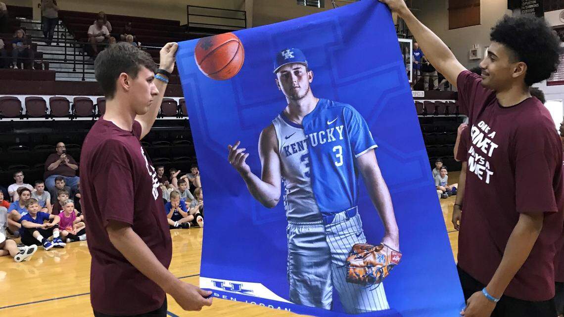 Kentucky players Brennan Canada, left, and Jacob Toppin displayed a poster of the late Ben Jordan, a UK baseball and basketball player who died in January at age 23.