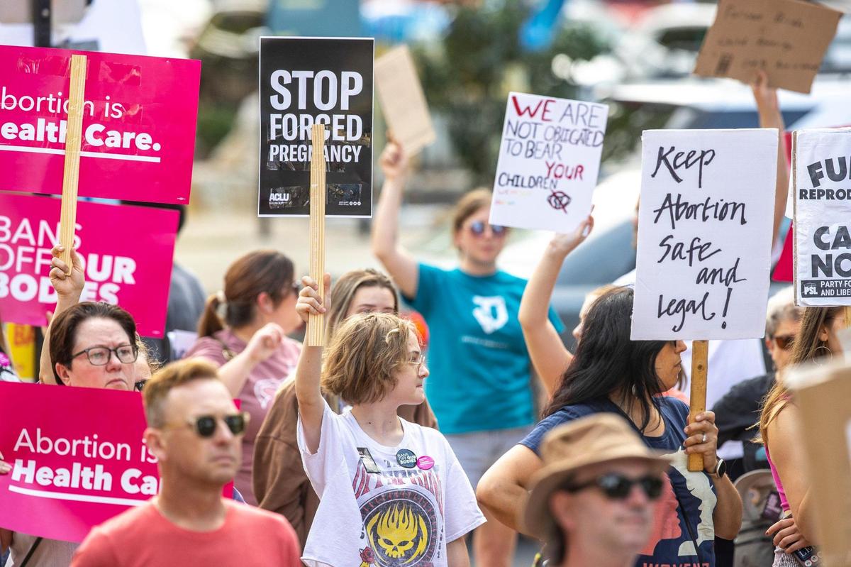 People gather near Robert F. Stephens Courthouse Plaza in downtown Lexington, Ky., on Friday, June 24, 2022 to protest the U.S. Supreme Court’s overturning of Roe v. Wade.