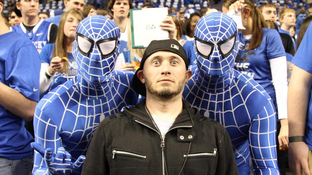 Jason Epperson, director of Sixth Man — a Krazy Love Story,  posed with two Cats fans known for their distinctive game wardrobe. The two were interviewed for the documentary.  