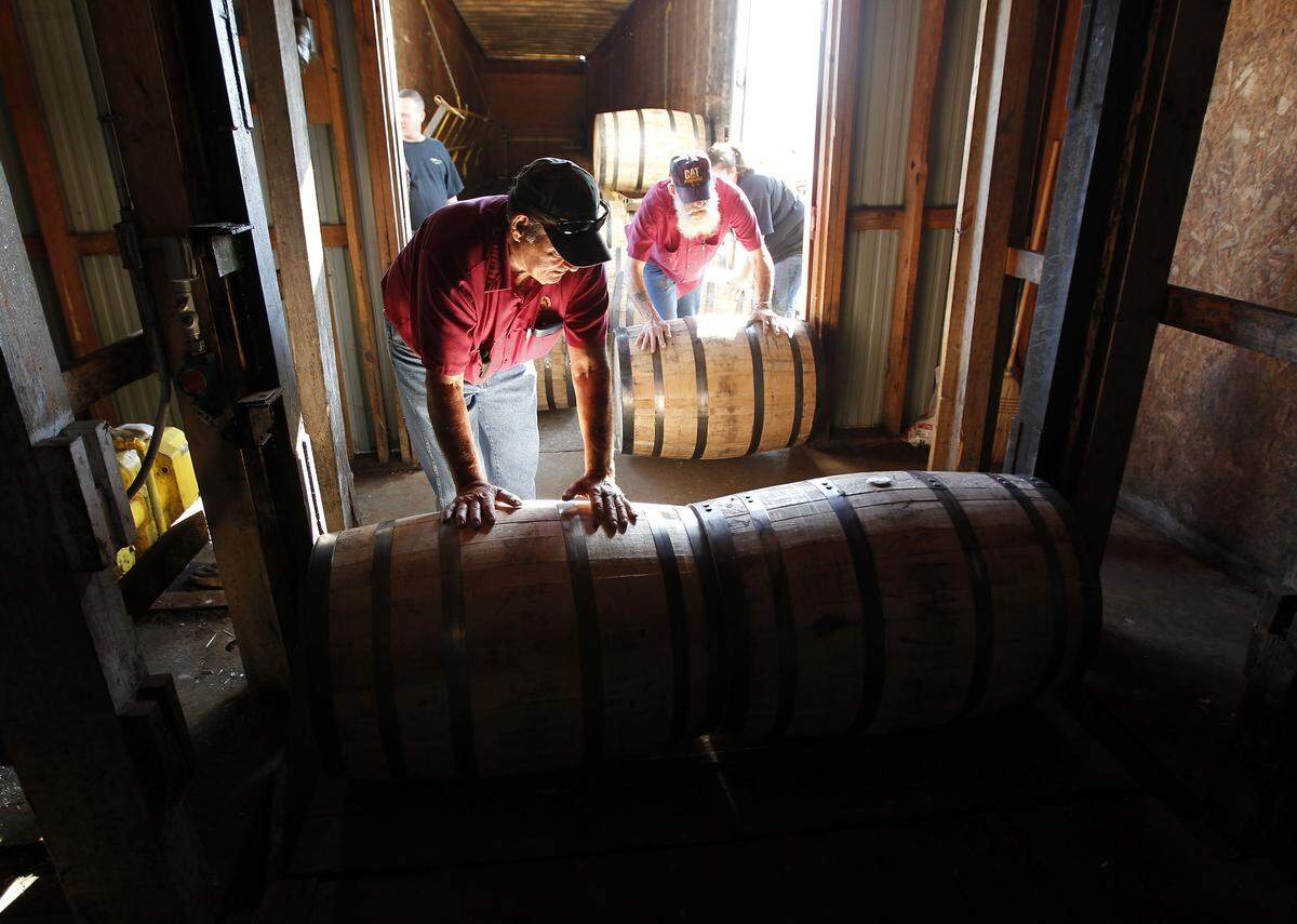 At the Wild Turkey Distillery in Lawrenceburg, Ray Caldwell, left, Kenny Hatchell and Mendey Pittman rolled recently filled barrels into a warehouse in 2013.