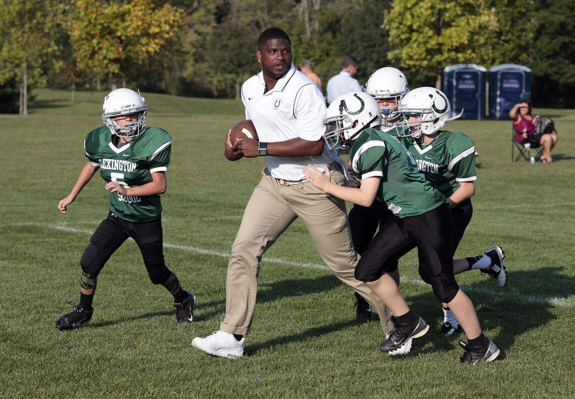 Former Kentucky Wildcats and Henry Clay Blue Devils quarterback, Shane Boyd (tan pants) demonstrated a play during a middle school practice for The Lexington School in 2014. Boyd, who signed contracts with 17 different professional football teams in the NFL, Arena Football League and United Football League, will be inducted into the Lexington African-American Sports Hall of Fame on Saturday night.
