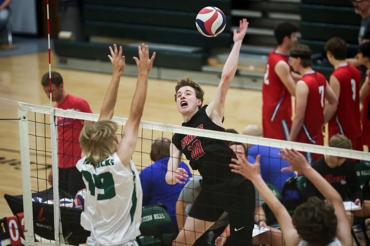 Paul Laurence Dunbar’s Gabe Sterlitz spikes the ball against Trinity during the KVCA boys volleyball semifinals at Western Hills High School in Frankfort on Thursday.