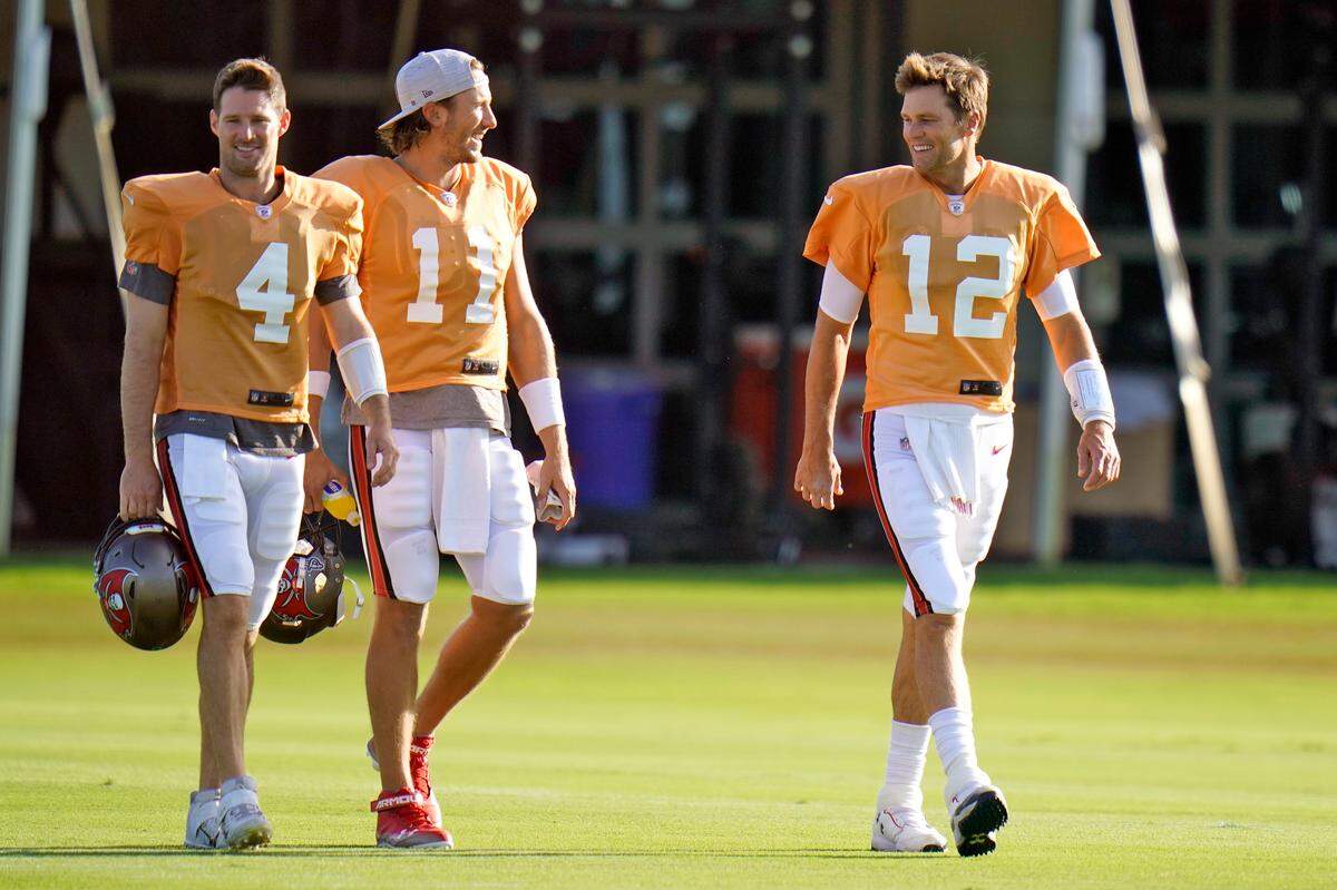 Buccaneers quarterbacks, from left, Ryan Griffin (No. 4), Blaine Gabbert (11) Tom Brady (12), get ready for a training camp practice last summer in Tampa.