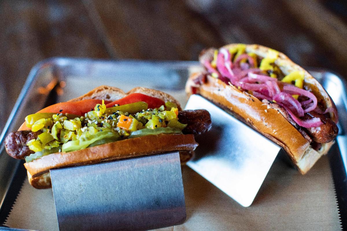 The Kentucky Dog, left, and the Hambassador from gourmet hot dog restaurant Boonedogs Bar and Restaurant on scenic Old Richmond Road. The menu features locally sourced items from regional producers.