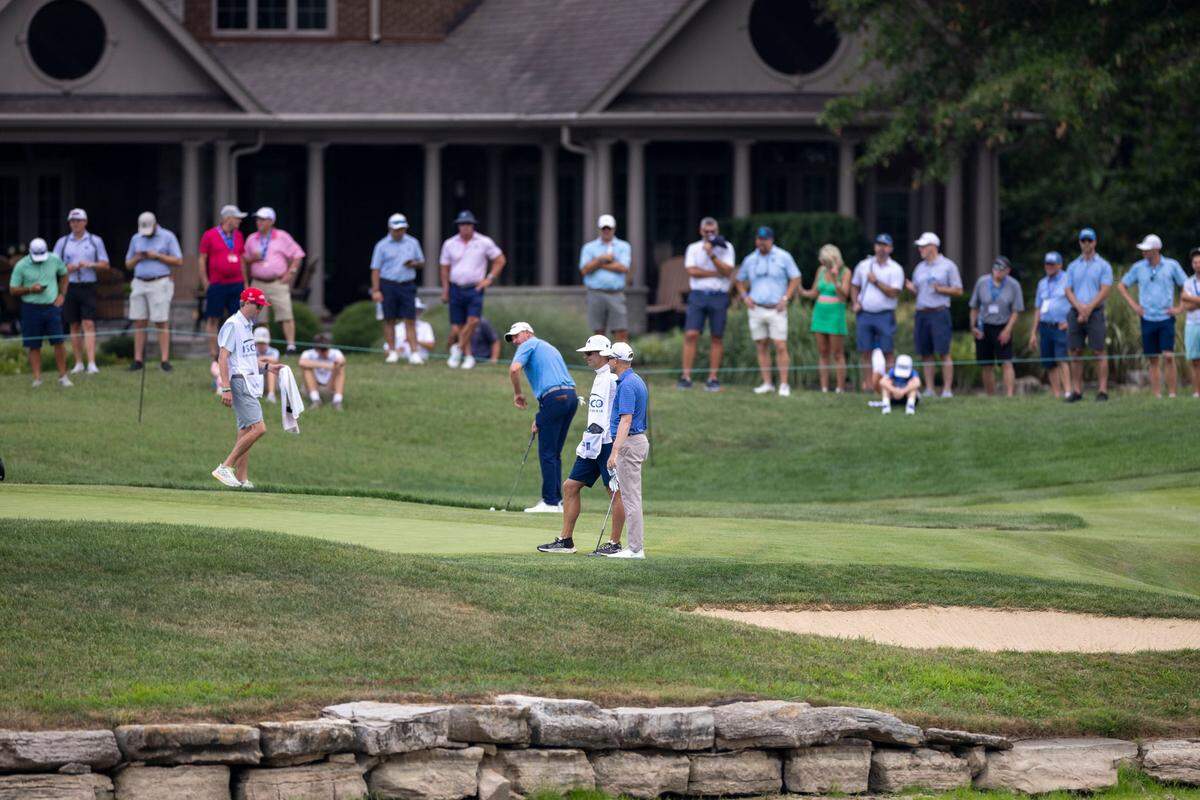 Golfers putt on the eighth hole as spectators watch during the first round of the 2024 ISCO Championship at Champions at Keene Trace Golf Club in Nicholasville on Thursday. The 2024 ISCO Championship set a record for the lowest 36-hole cut-line score in an individual, stroke-play event in PGA Tour history.