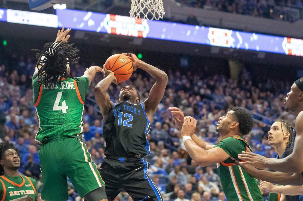 Kentucky guard Antonio Reeves (12) takes a shot as Florida A&M guard Hantz Louis-Jeune (4) defends during Wednesday’s game at Rupp Arena.