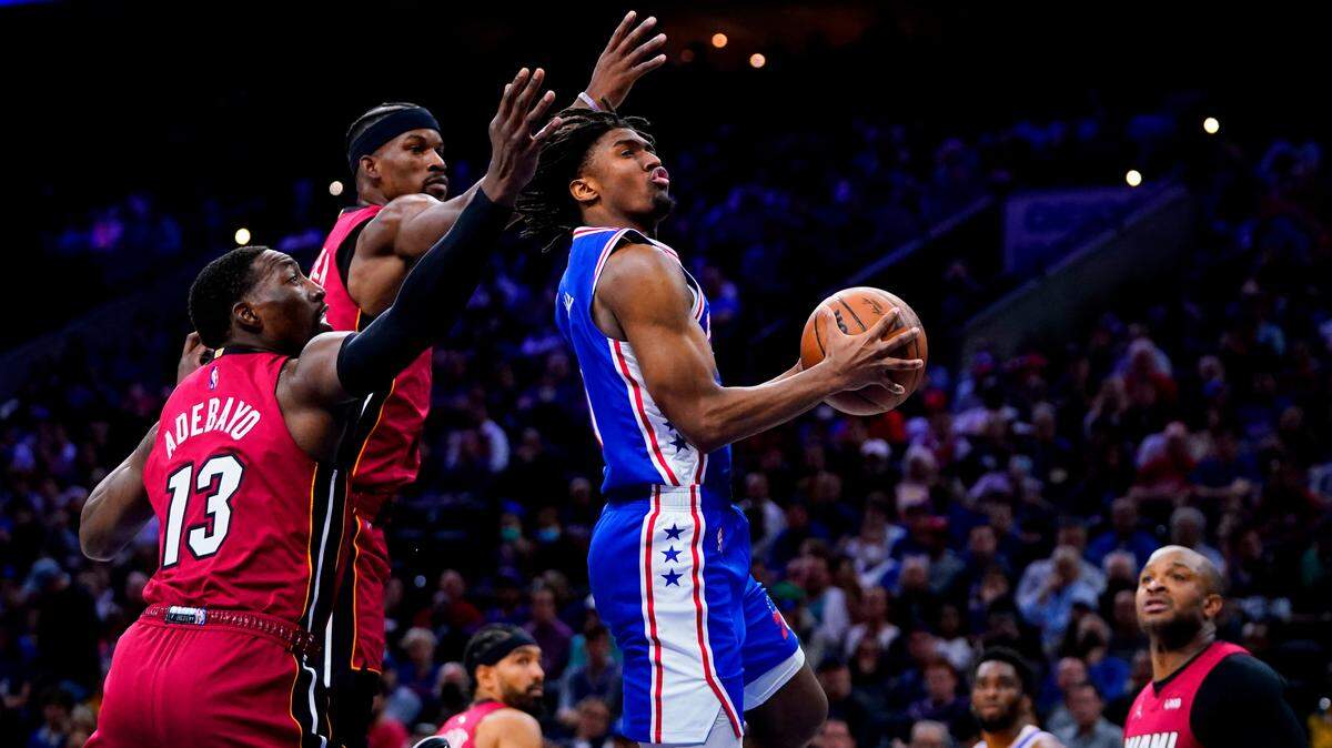 The Philadelphia 76ers’ Tyrese Maxey goes up for a shot against Miami Heat’s Bam Adebayo (13), Jimmy Butler, second left, and P.J. Tucker (17) on May 12, 2022.