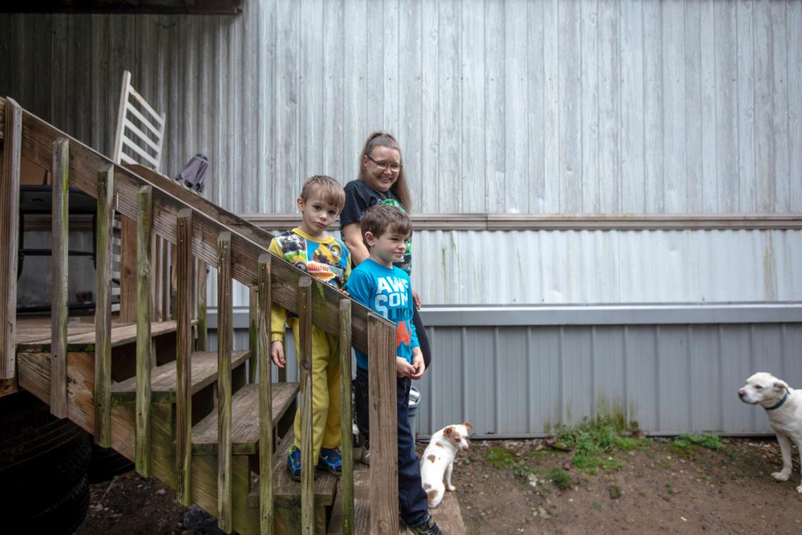 Tonya Hall stands outside her home with her grandsons Jayden Hall, left, and Hyden Hall, in Floyd County, Ky., on Thursday, March 19, 2020.