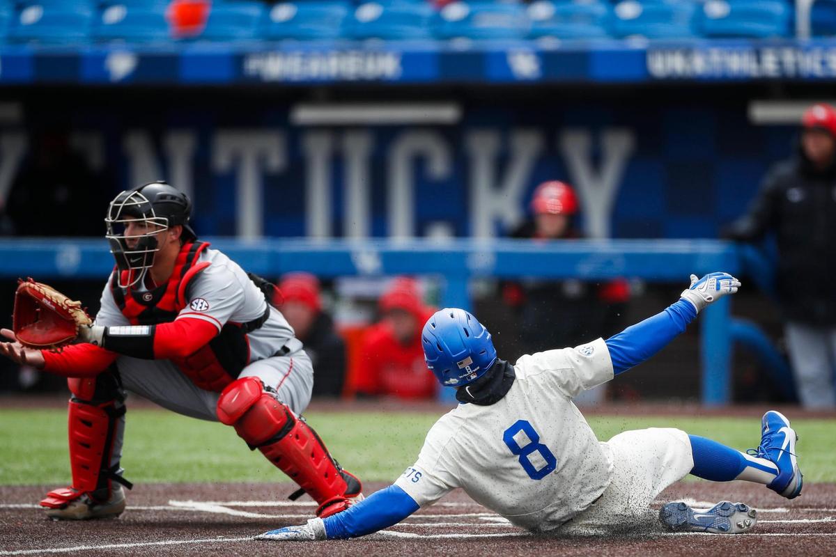Kentucky utility player Kirk Liebert slides into home to score against Georgia during Saturday’s game.