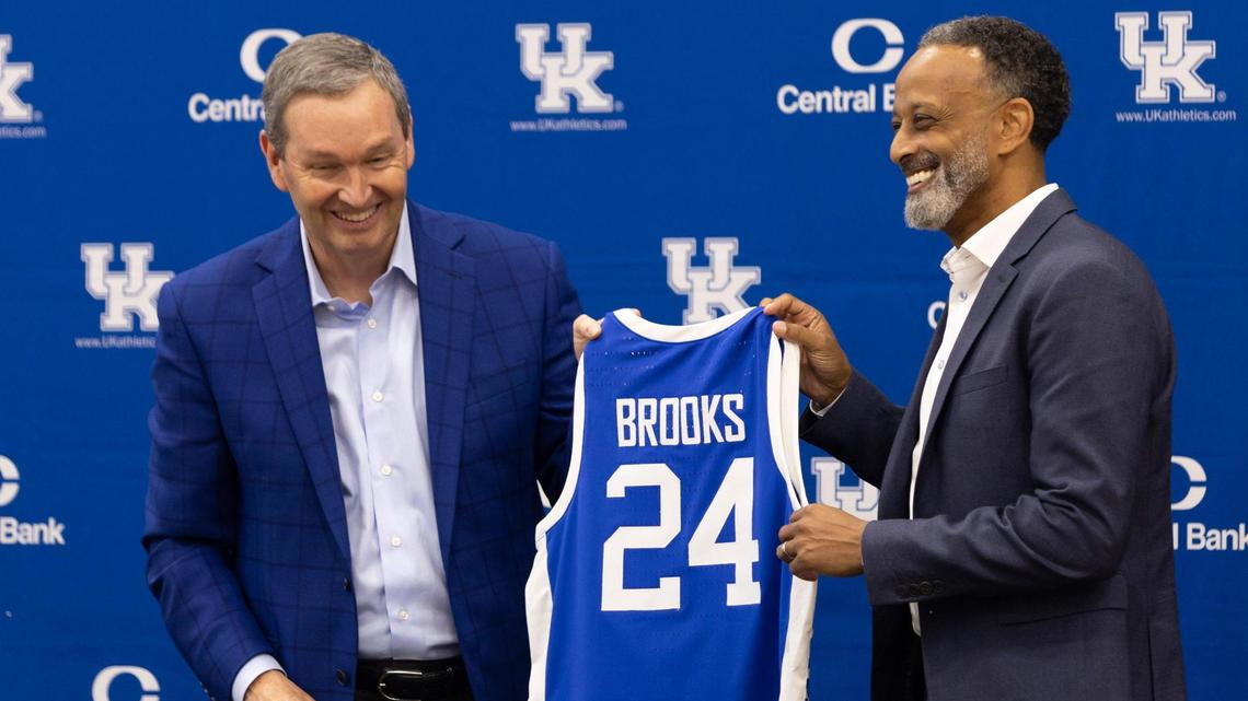 Kentucky athletics director Mitch Barnhart, left, noted that new UK women’s basketball coach Kenny Brooks “went 2-0 against Tennessee and 3-0 against Louisville” the past two seasons.
