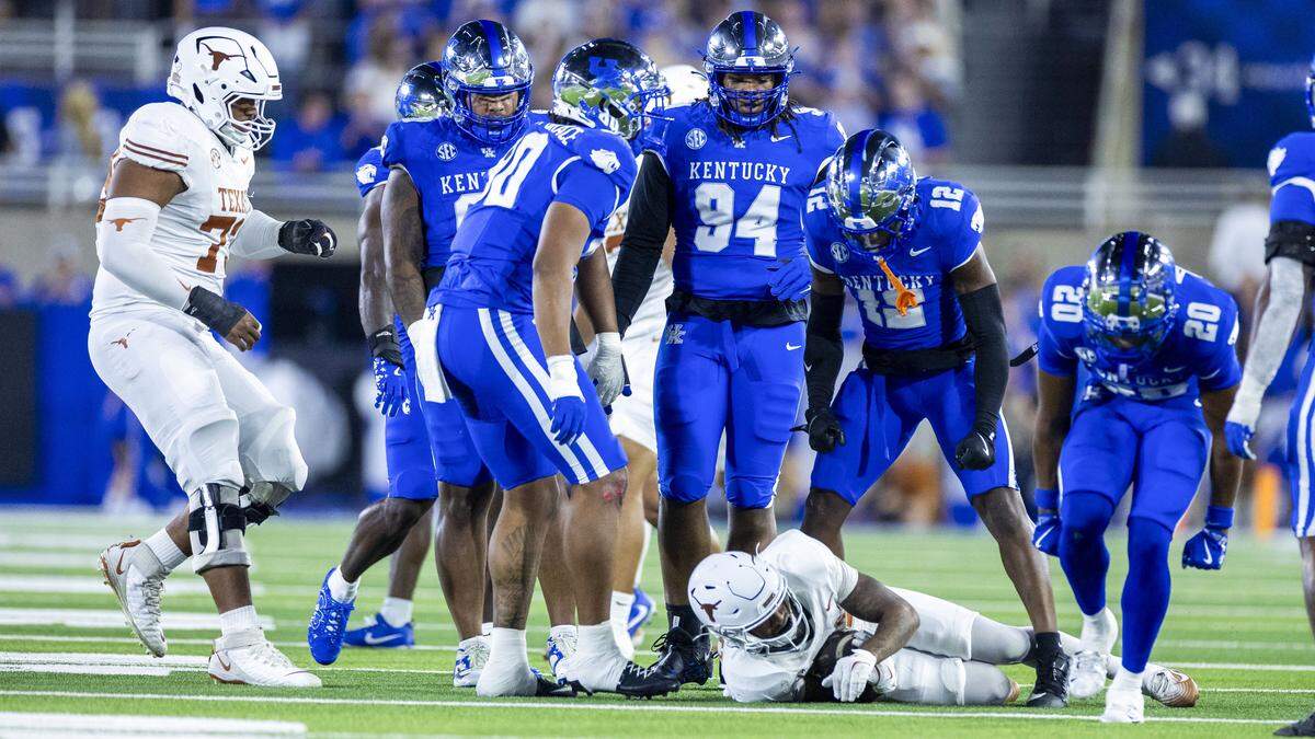 Kentucky defensive back Quay'Sheed Scott (12) celebrates after the UK defense brought down Texas wide receiver Ryan Niblett (21) during Saturday’s game against Texas.