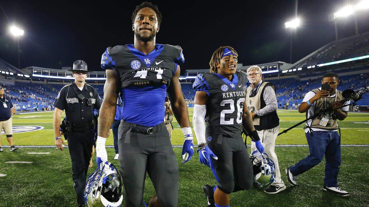 Kentucky linebacker Josh Allen, left, and running back Benny Snell walked off the field following the Cats’ 24-10 victory against South Carolina.