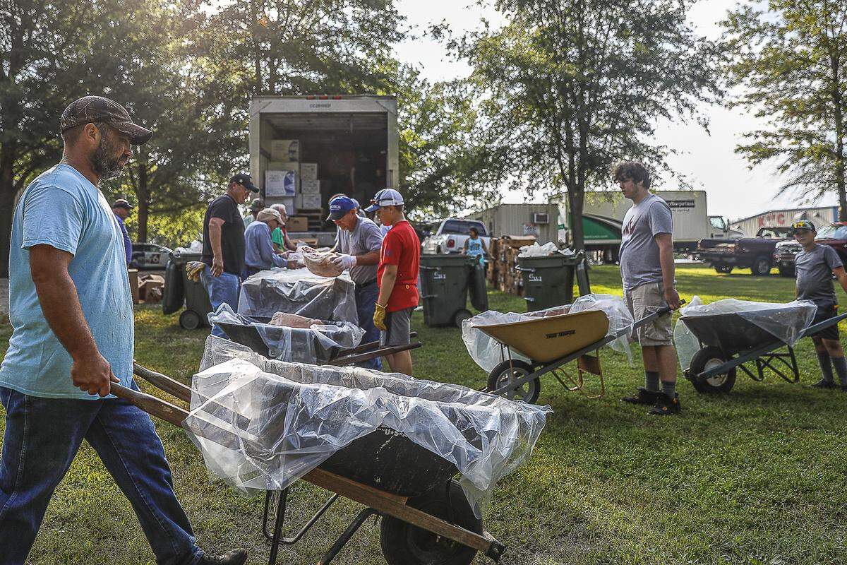 Pork is loaded into wheelbarrows to be transported to the barbecue pits on the grounds of St. Jerome Catholic Church in Fancy Farm, Ky., Friday, Aug. 2, 2019, in preparation of the Fancy Farm Picnic. Nine tons of pork and mutton are being prepared.
