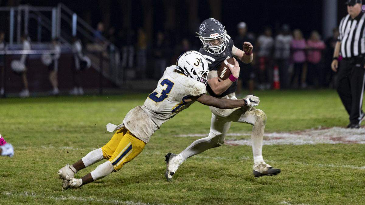 Sayre’s Caden Jones (3) chases down Holy Cross quarterback Jerek Hoover on a fourth-quarter play that led to a sack during the Spartans’ 34-20 win at Holy Cross High School in Louisville on Friday.