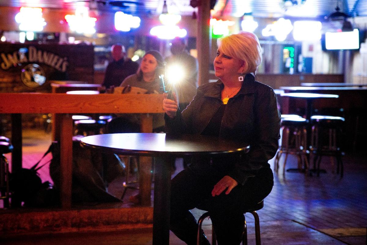 Renee Cobb, co-host of Overtones, records Matthew Douglas Simpson and his band at Austin City Saloon in Lexington, Ky., on Wednesday, Feb. 24, 2021.