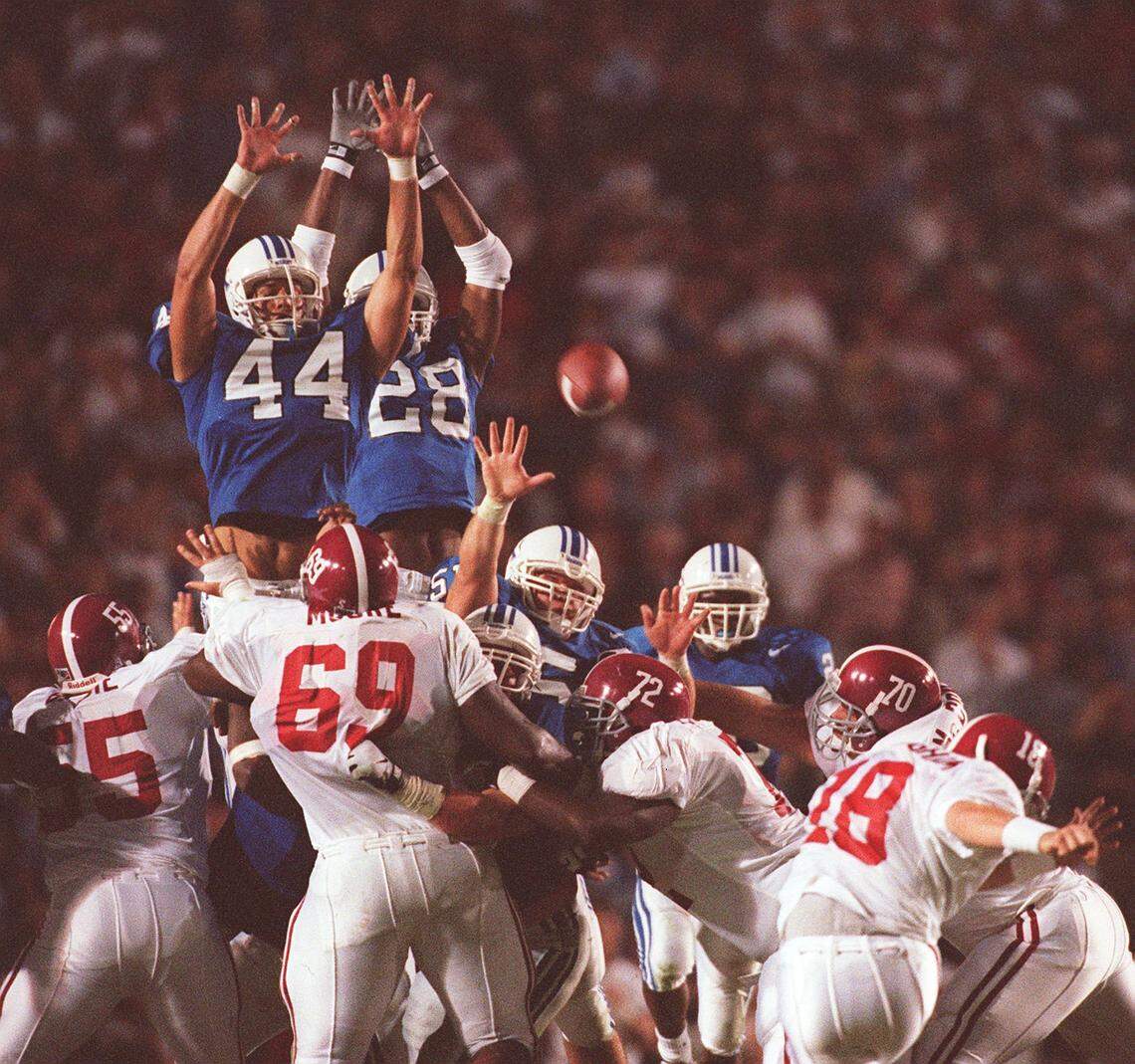 UK’s David Ginn (44) and Jermaine White (28) leap to block an Alabama field goal late in Kentucky’s 40-34 overtime win over the Crimson Tide in 1997. Ginn blocked the field goal attempt and Anwar Stewart returned it for a TD.
