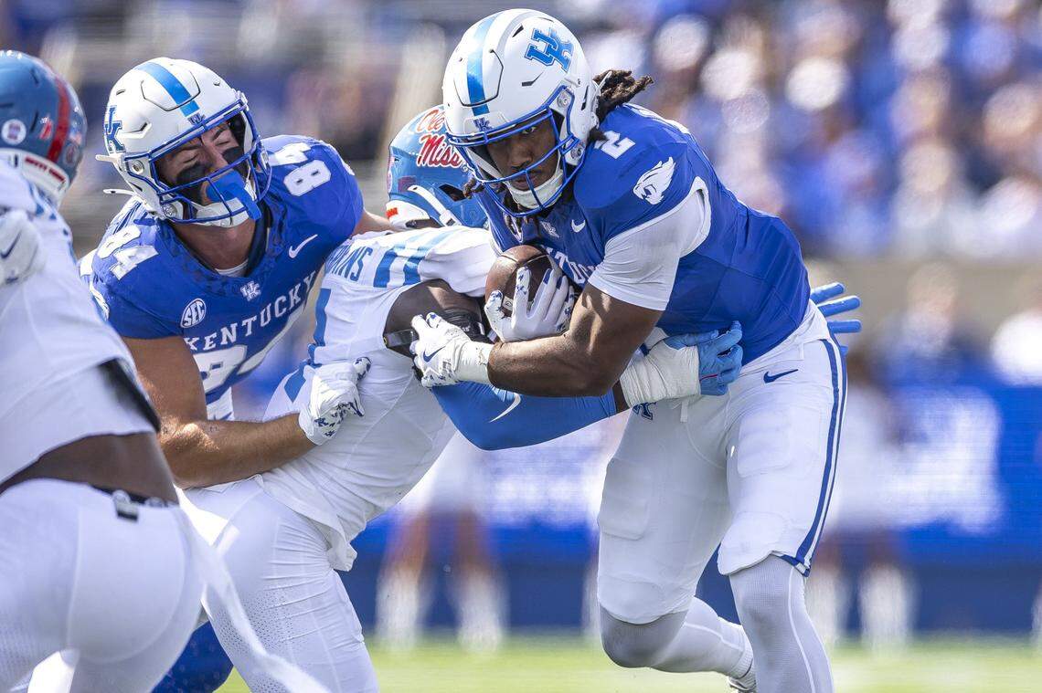 Kentucky running back Dante Dowdell (2) is wrapped up by Mississippi linebacker Suntarine Perkins (4) during Saturday’s game at Kroger Field.