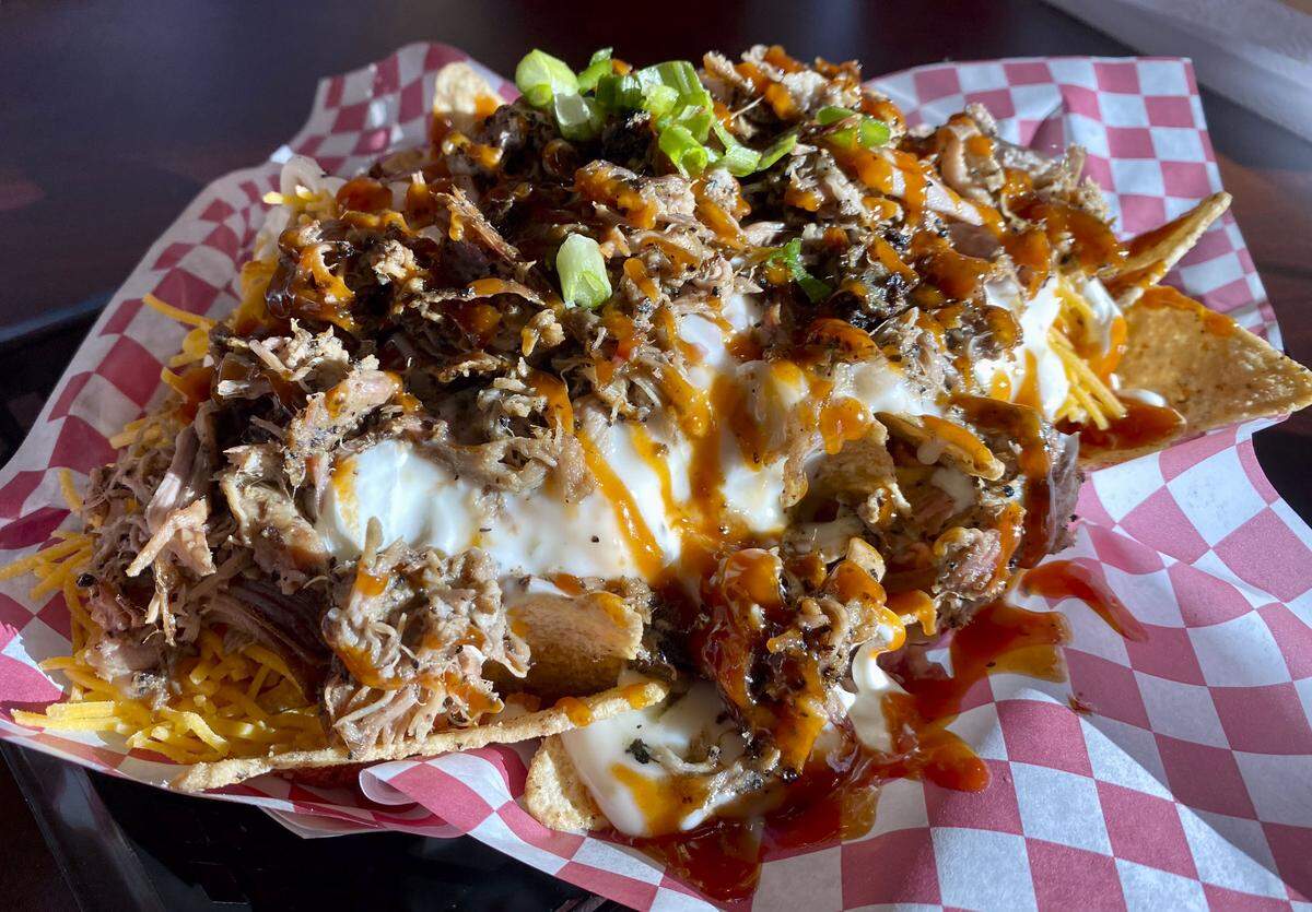 Smokehouse nachos at Thatcher Barbecue Company, made with pulled pork (can also come with chicken) and served with tortilla chips, pico de gallo, sour cream, queso and jalapenos.