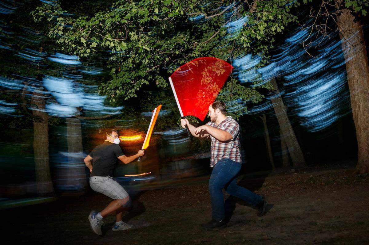 Jonathan Thompson, left, and Mike Thompson, both of Lexington, duel each other with plastic lightsabers during a Wednesday practice session with the Lexington Lightsaber League at Woodland Park. Members train in seven lightsaber fighting styles from the Star Wars universe. The club meets every Wednesday at Woodland Park beginning at 6:30 p.m. and new members are welcome.