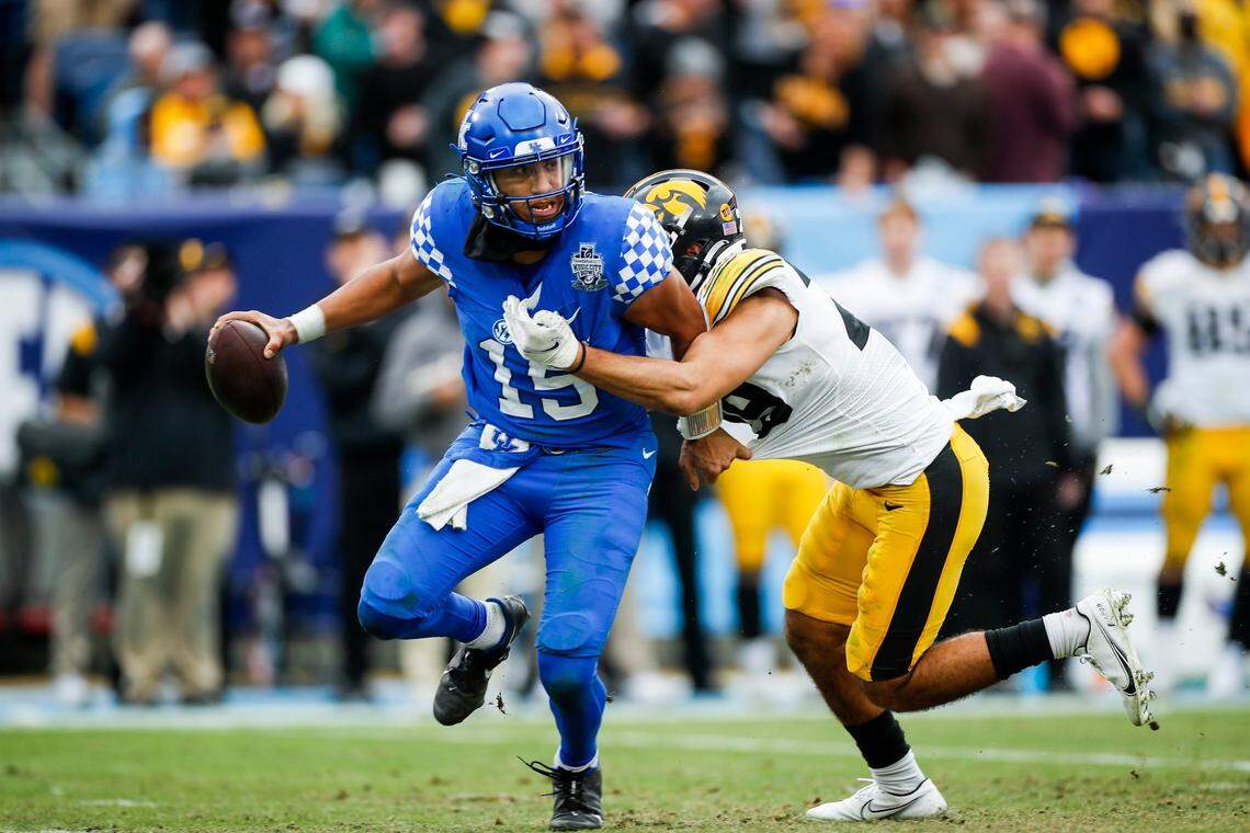 Kentucky QB Destin Wade (15) is sacked during the Cats’ Music City Bowl loss. UK was held to 185 yards of offense and Wade threw a pair of pick sixes against Iowa.