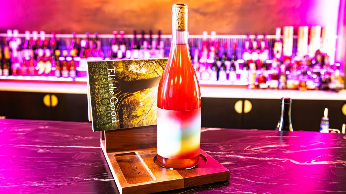 A citrus, fruity, non-filtered blend in a colorful bottle, paired with a good book, sold at the new speakeasy located inside District 7 Social in Lexington’s Distillery District called Book Club Wine Room at 1170 Manchester St #160 on May 23, 2025, in Lexington, Ky.