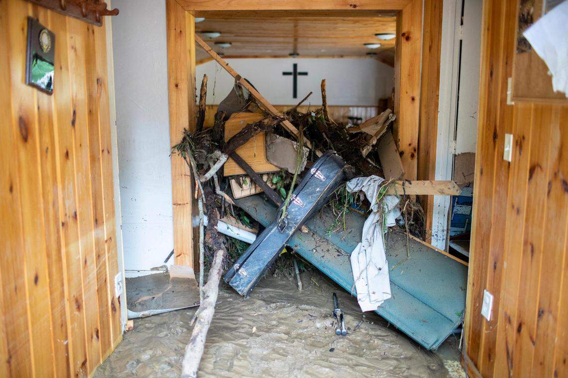 Debris, including a guitar case, are packed into the doorway of a church after severe flooding in Perry County, Ky., Friday, July 29, 2022.