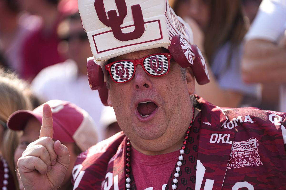 Oct 8, 2022; Dallas, Texas, USA: Oklahoma Sooners fan Joel McKennon cheers for his team during the annual Red River Showdown against the Texas Longhorns at the Cotton Bowl. Mandatory Credit: Aaron E. Martinez/Austin American-Statesman- USA TODAY NETWORK