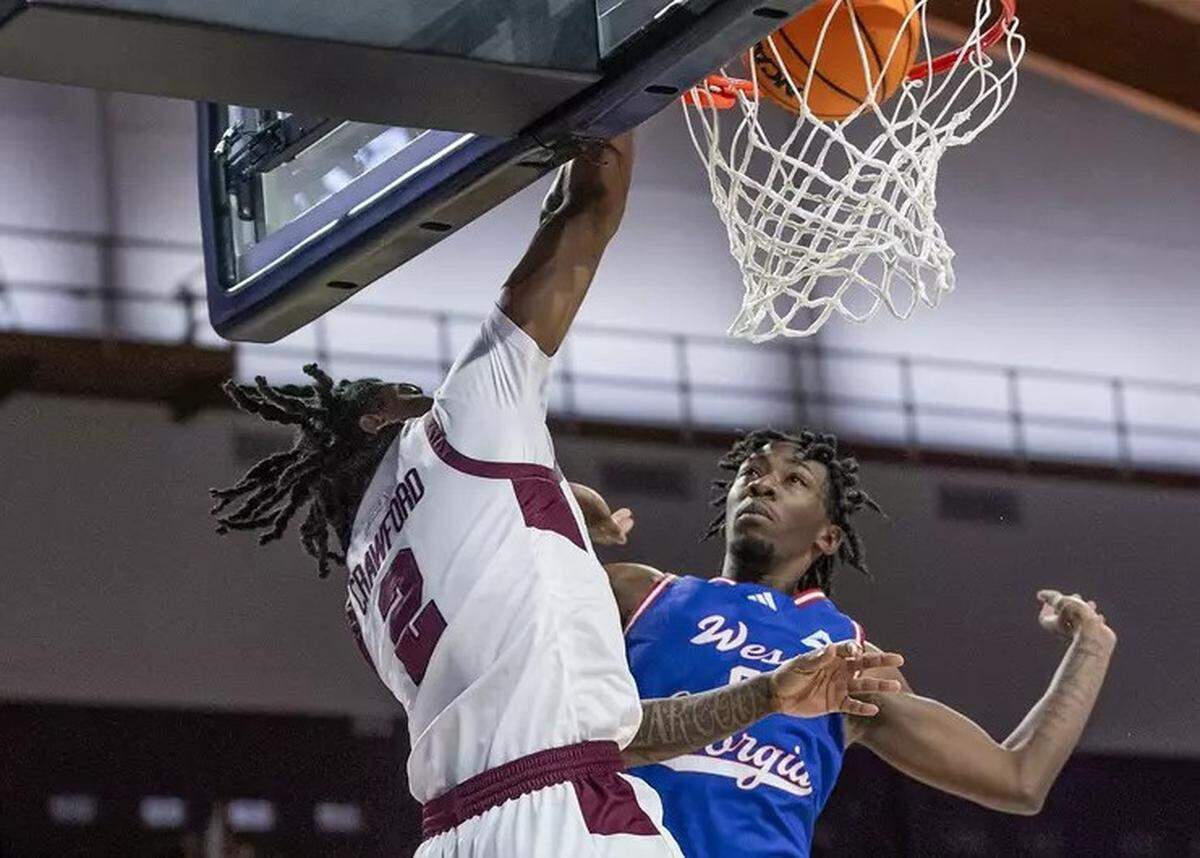 Eastern Kentucky’s Jordan Crawford dunks over West Georgia’s Kyric Davis during the Colonels’ sixth straight victory on Thursday night. Crawford finished with 22 points.
