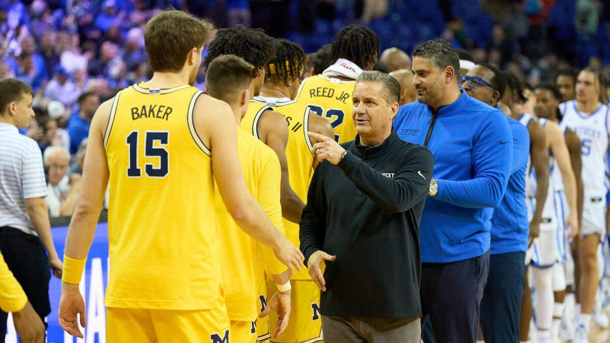 Kentucky head coach John Calipari shakes hands with Michigan players after the Wildcats’ win over the Wolverines at O2 Arena in London last December. What was supposed to be a three-game series between UK and UM has come to an end with only that one game played.